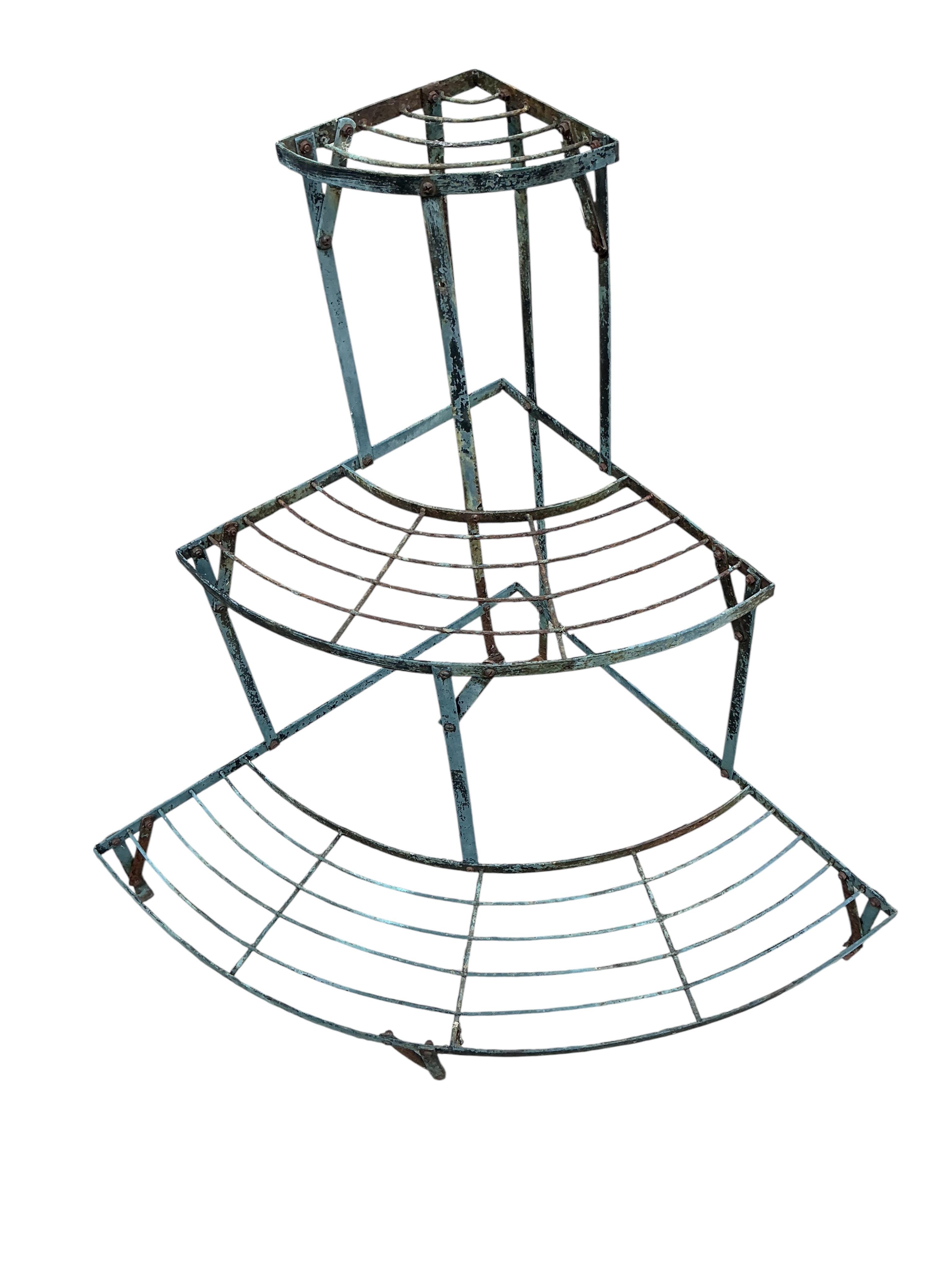 A wrought iron three section three tier pot stand, width 108cm, height 75cm